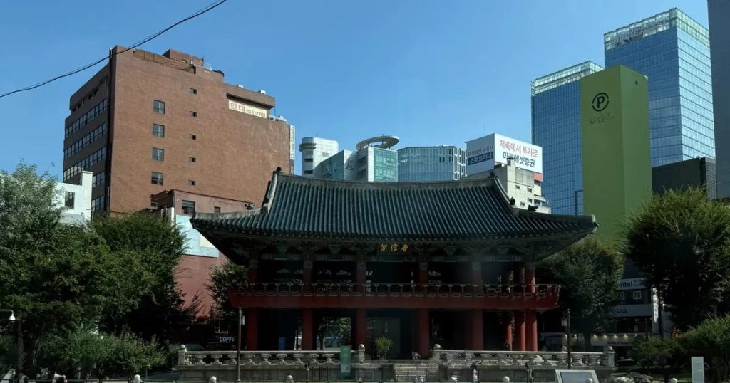 Traditional Korean pavilion surrounded by modern buildings in Seoul